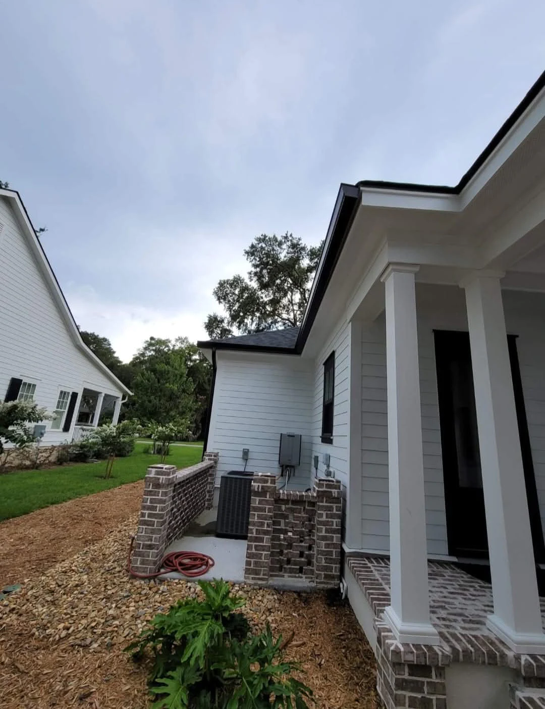 Supporting elevation shot of custom black gutters installed in Beaufort, South Carolina